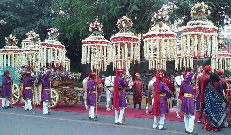 Flower-decorated band cart with lights at a night event